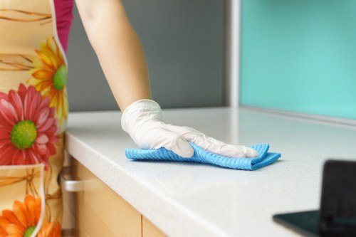 Cleaner preparing a Kentishtown property for move in with detailed surface cleaning