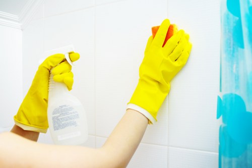 Cleaner working on a corner sofa in a local Kentishtown apartment